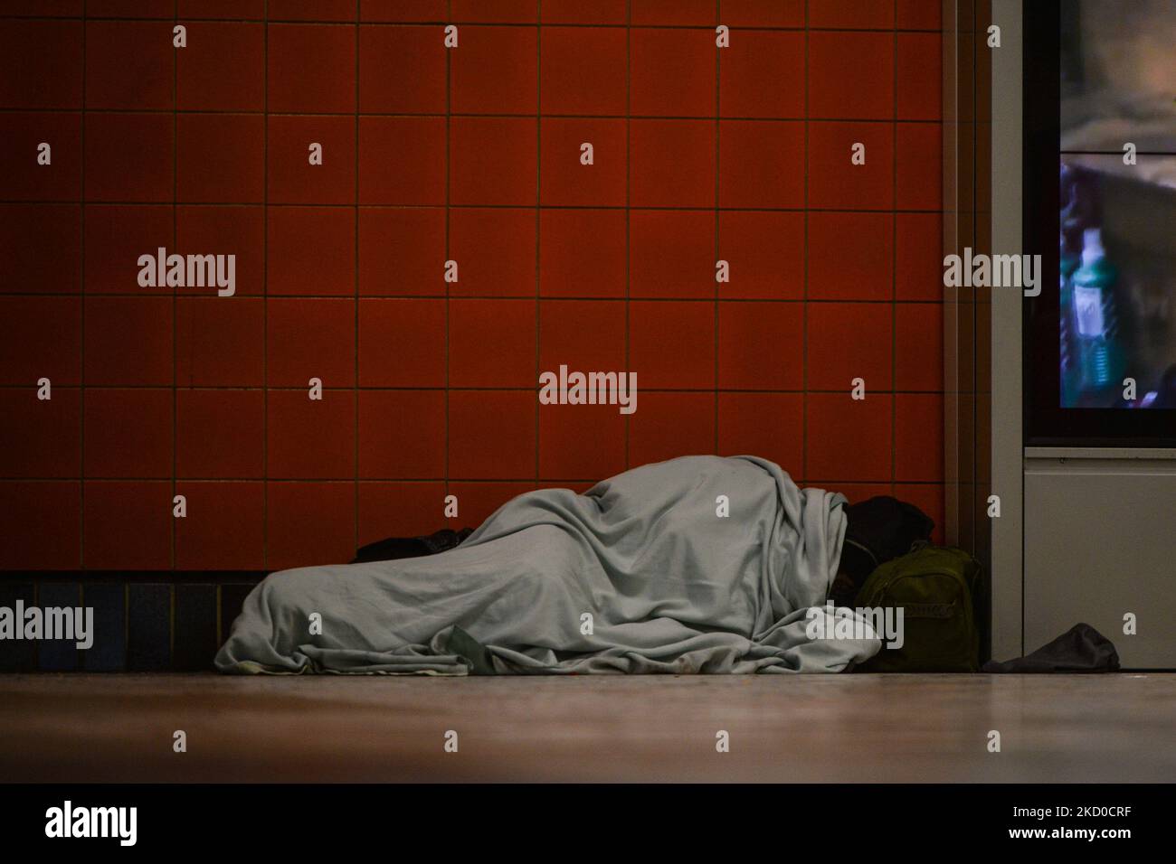 A homeless person sleeping at the entrance to an LRT station in ...