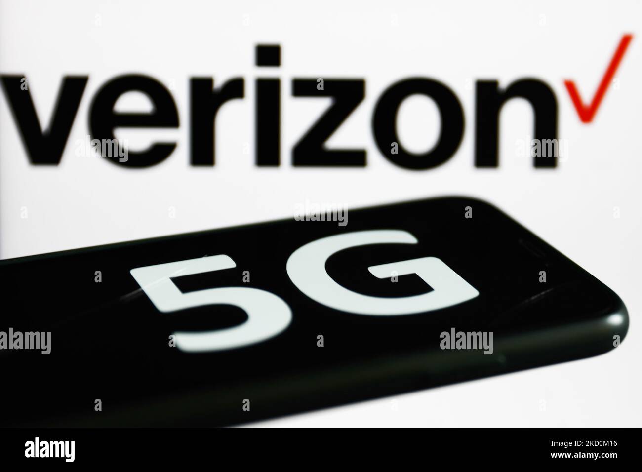 5G sign displayed on a phone screen and Verizon logo displayed on a