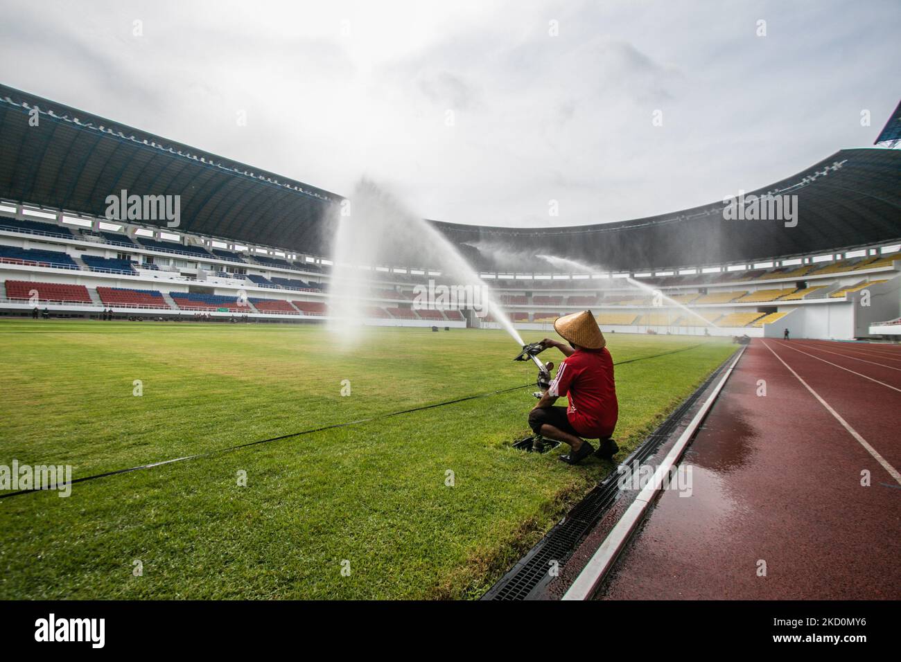 Workers take care of the grass species Zoysia japonica from Italy at the Jatidiri Stadium in Semarang, Central Java Province, Indonesia on January 18, 2022. According to the Central Java Provincial Government, the renovation of the stadium which has been carried out since 2016 with a capacity of 20,000 seats without a single seat to around 25,000 seats using one seat. The use of the stadium is targeted for 2023 which is currently in the stage of fulfillment and application for certification and leveraging of AFC and FIFA standards. (Photo by WF Sihardian/NurPhoto) Stock Photo