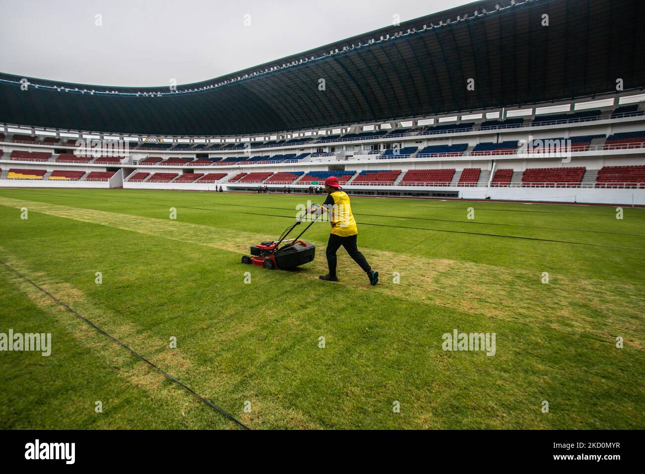 Workers take care of the grass species Zoysia japonica from Italy at the Jatidiri Stadium in Semarang, Central Java Province, Indonesia on January 18, 2022. According to the Central Java Provincial Government, the renovation of the stadium which has been carried out since 2016 with a capacity of 20,000 seats without a single seat to around 25,000 seats using one seat. The use of the stadium is targeted for 2023 which is currently in the stage of fulfillment and application for certification and leveraging of AFC and FIFA standards. (Photo by WF Sihardian/NurPhoto) Stock Photo