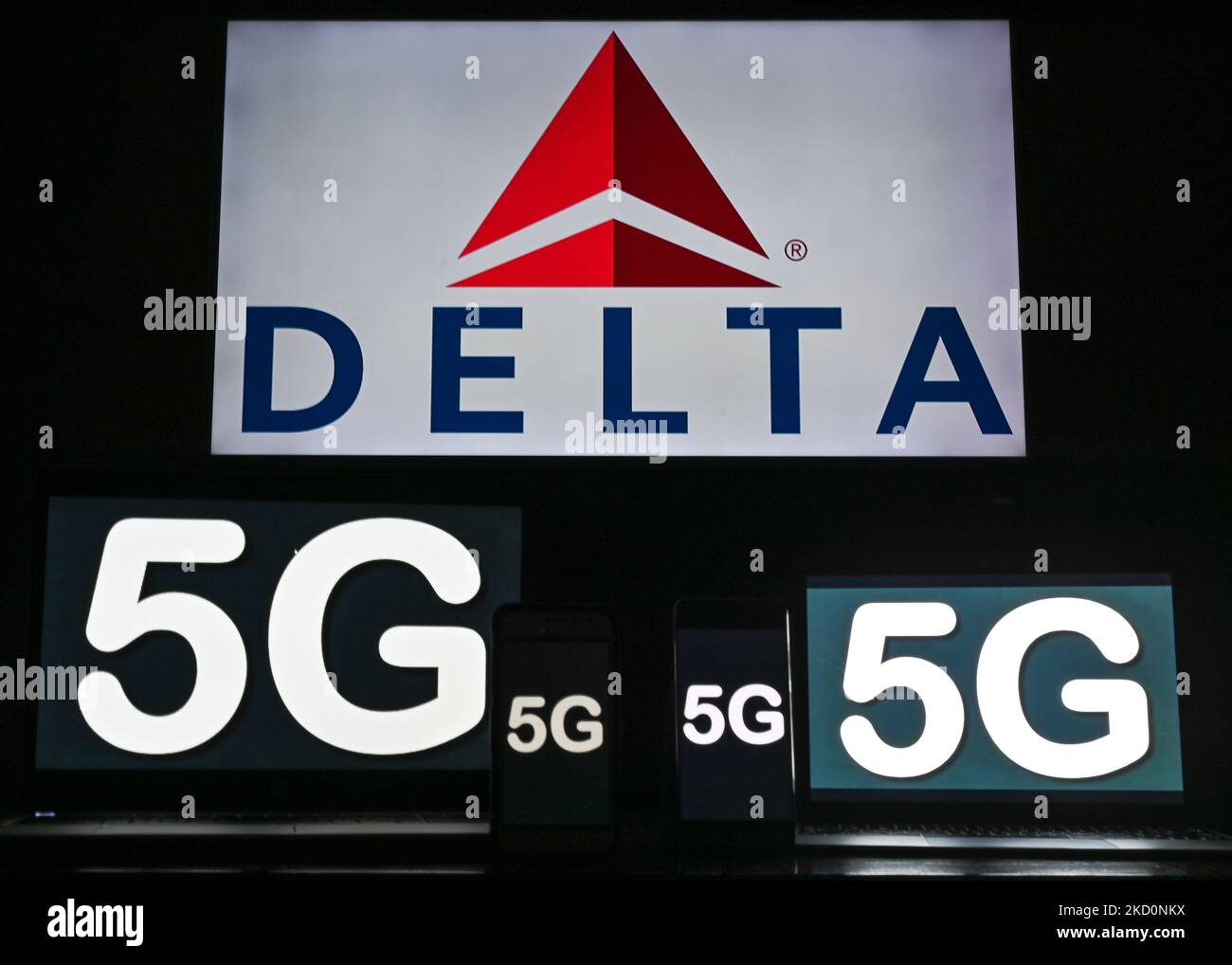 Images of the 5G sign displayed on the screens of mobile phones and computers in front of the Delta Air Lines logo displayed on the TV screen. On Tuesday, January 18, 2021, in Edmonton, Alberta, Canada. (Photo by Artur Widak/NurPhoto) Stock Photo