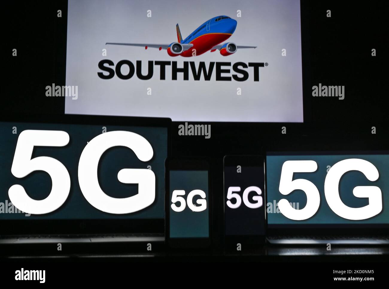 Images of the 5G sign displayed on the screens of mobile phones and computers in front of the Southwest Airlines displayed on the TV screen. On Tuesday, January 18, 2021, in Edmonton, Alberta, Canada. (Photo by Artur Widak/NurPhoto) Stock Photo