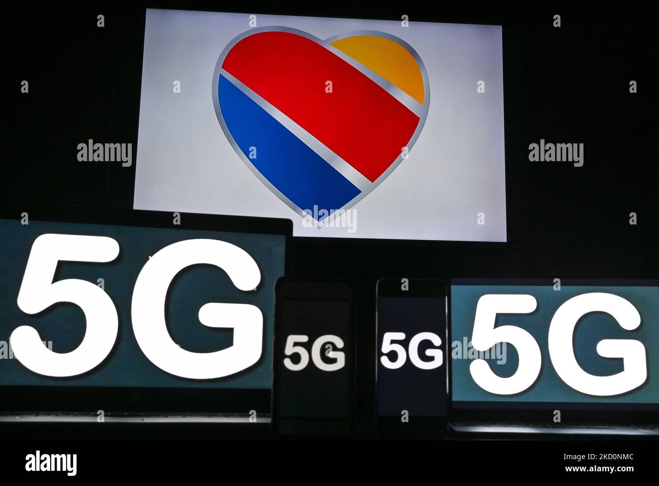 Images of the 5G sign displayed on the screens of mobile phones and computers in front of the Southwest Airlines displayed on the TV screen. On Tuesday, January 18, 2021, in Edmonton, Alberta, Canada. (Photo by Artur Widak/NurPhoto) Stock Photo