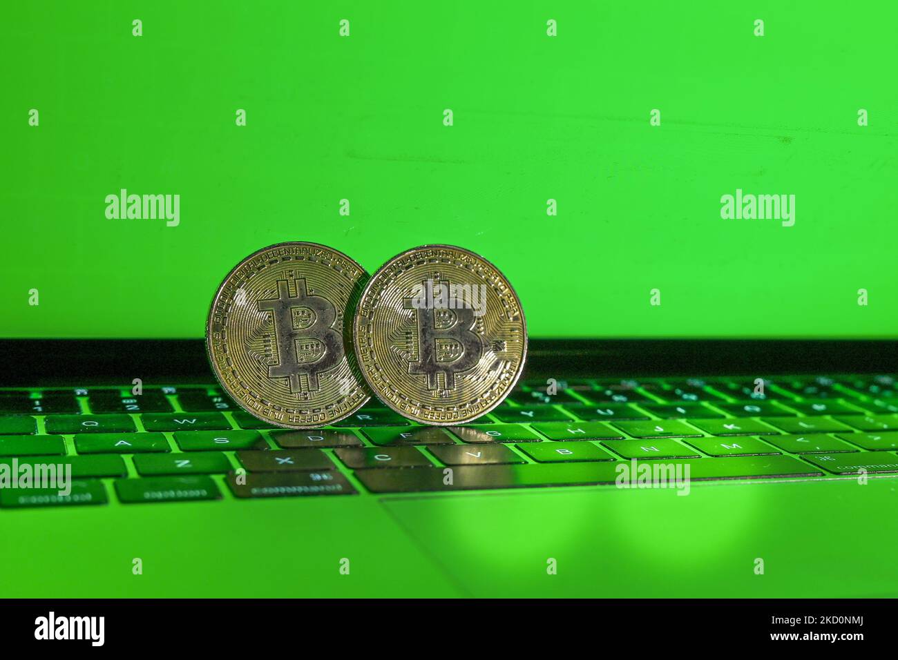 Illustrative image of two commemorative bitcoins with a green background. On Wednesday, January 19, 2021, in Edmonton, Alberta, Canada. (Photo by Artur Widak/NurPhoto) Stock Photo