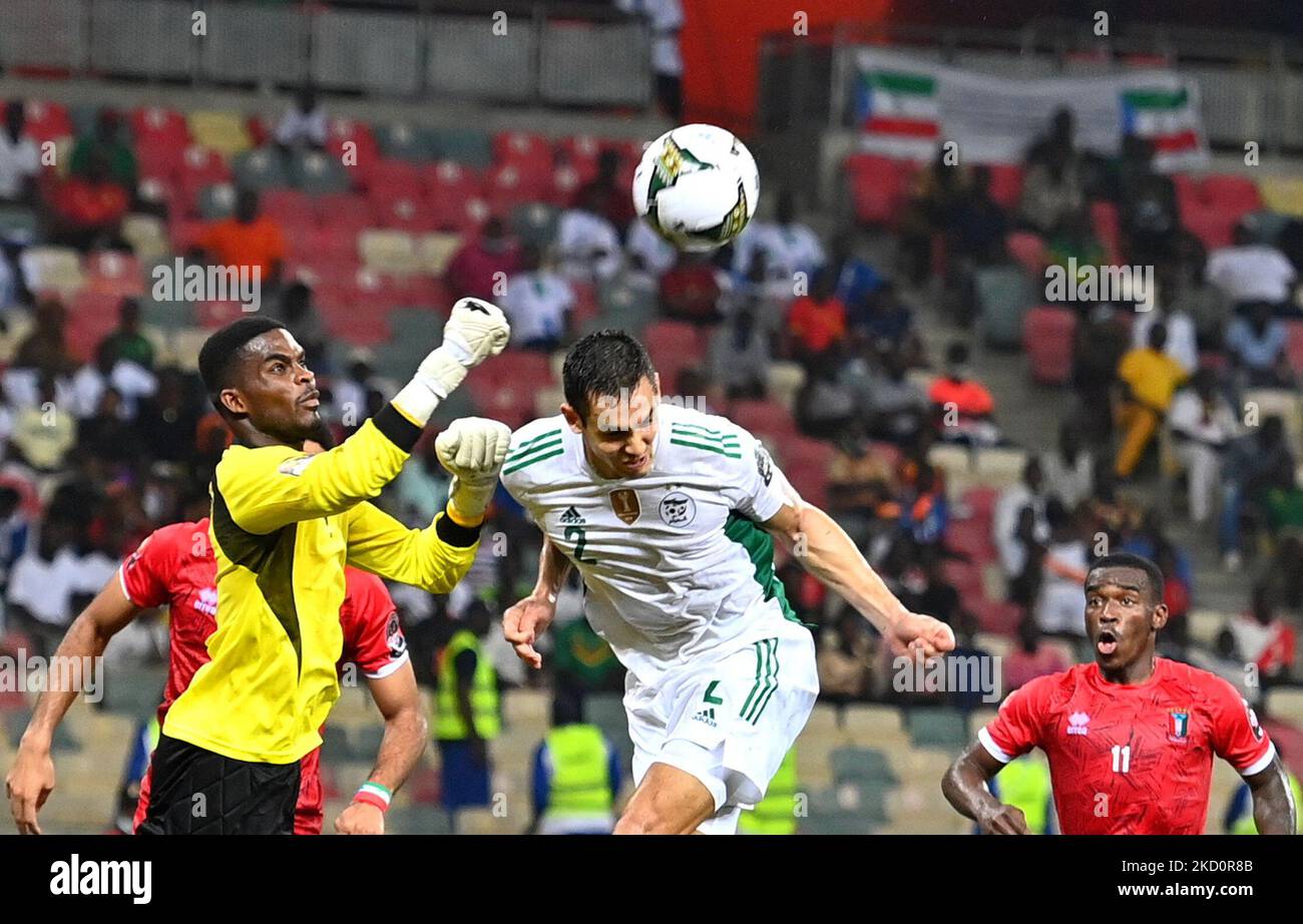 Equatorial Guinea's goalkeeper Jesus Owono Ngua saves at the feet of Aissa Mandi of Algeria (R) during the 2021 Africa Cup of Nations (CAN) Group E soccer match between Algeria and Equatorial Guinea at the Japoma Stadium in Douala on January 16, 2022 (Photo by APP/NurPhoto) Stock Photo