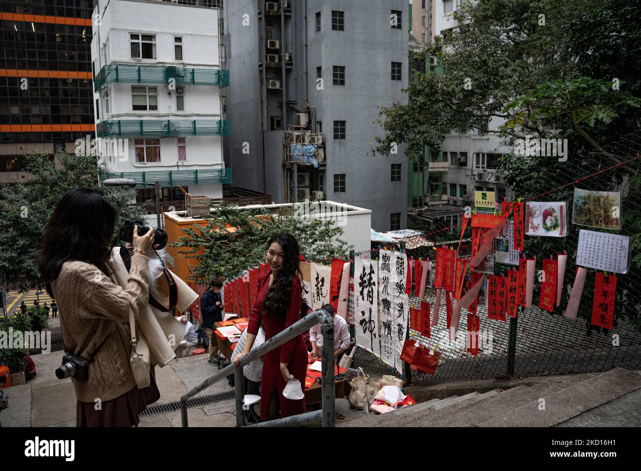 On January 24, 2022, Hong Kong, on the eve of the Chinese New Year in Hong Kong, some calligraphers wrote lucky messages on the street, and some citizens took pictures. (Photo by Leung Man Hei/NurPhoto) Stock Photo