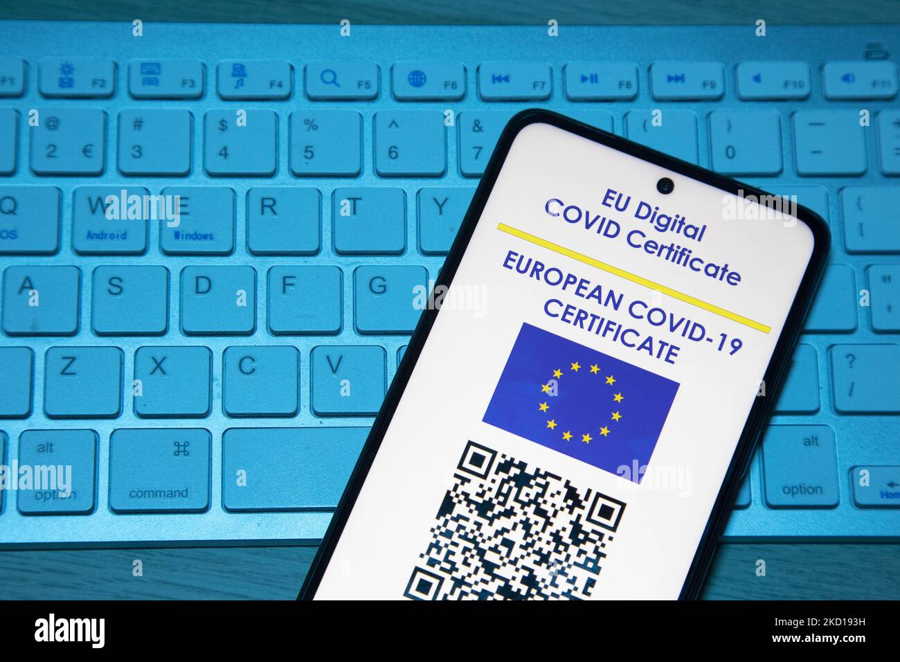 Photo illustration of a display of a mobile phone with a European EU digital Covid-19 vaccination certificate with a QR, an international vaccination certificate or health pass on a computer keyboard with blue light. Photo on the subject of fake vaccination certificates. Currently, the pandemic spread is on the fifth wave of the coronavirus with the omicron mutation being the dominant variant. Amsterdam, the Netherlands on January 25, 2022 (Photo by Nicolas Economou/NurPhoto) Stock Photo