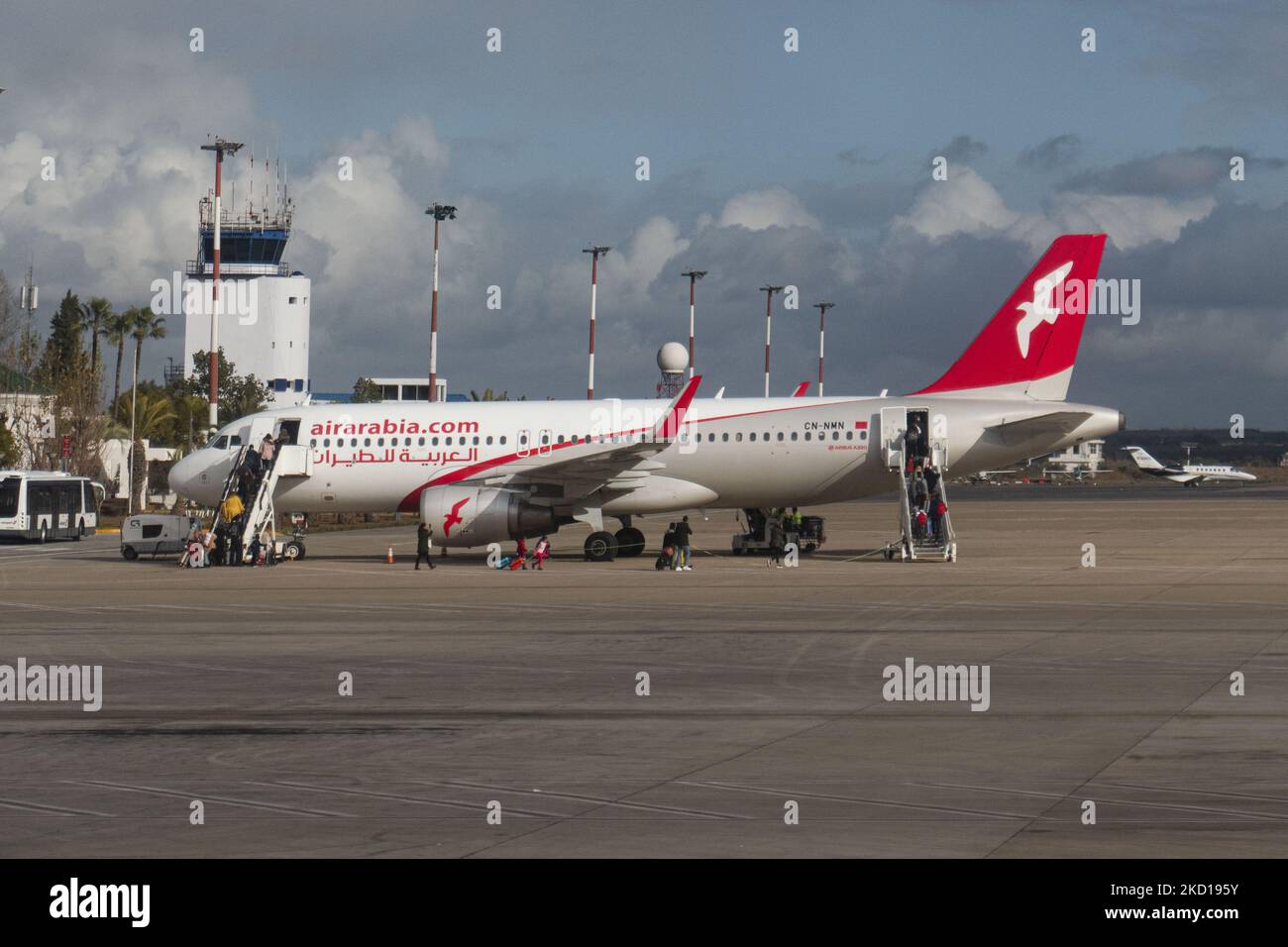 Air Arabia Maroc Airbus A320 aircraft as seen at Fes - Sais Airport near the city of Fez while passenger are seen boarding the plane. The Airbus jet airplane has the registration CN-NMN. Air Arabia Maroc is a Moroccan low cost airline subsidiary of AirArabia. Fes, Morocco on January 19, 2020 (Photo by Nicolas Economou/NurPhoto) Stock Photo