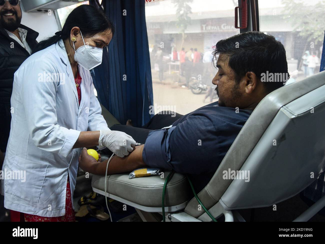 Volunteers donates blood in a blood donation camp on the occasion of