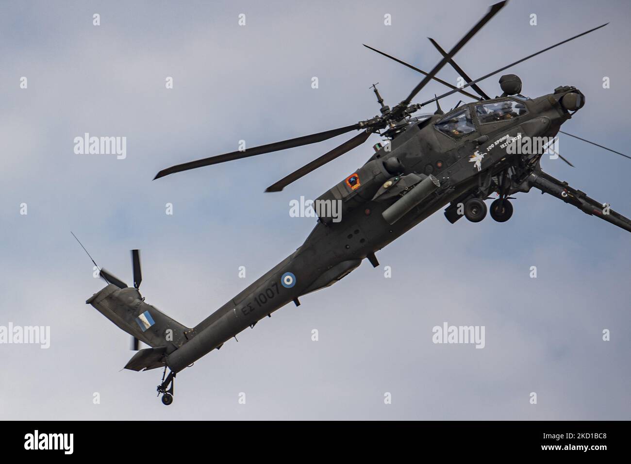 A Boeing AH-64 Apache helicopter and a Bell OH-58 Kiowa army helicopter from the Greek Army as seen flying and manoeuvering during a flying display demonstration during Athens Flying Week 2021 Air Show at Tanagra Air Base Airport. The Apache of the Hellenic military is the AH-64D Apache Longbow version. The specific aircraft is a twin turboshaft attack combat helicopter under the fuselage and on the wings with a machine gun, missiles, rocket and self defense capabilities. Greece, a country with strong air force is a member state of the North Atlantic Treaty Organization NATO. Tanagra, Greece o Stock Photo