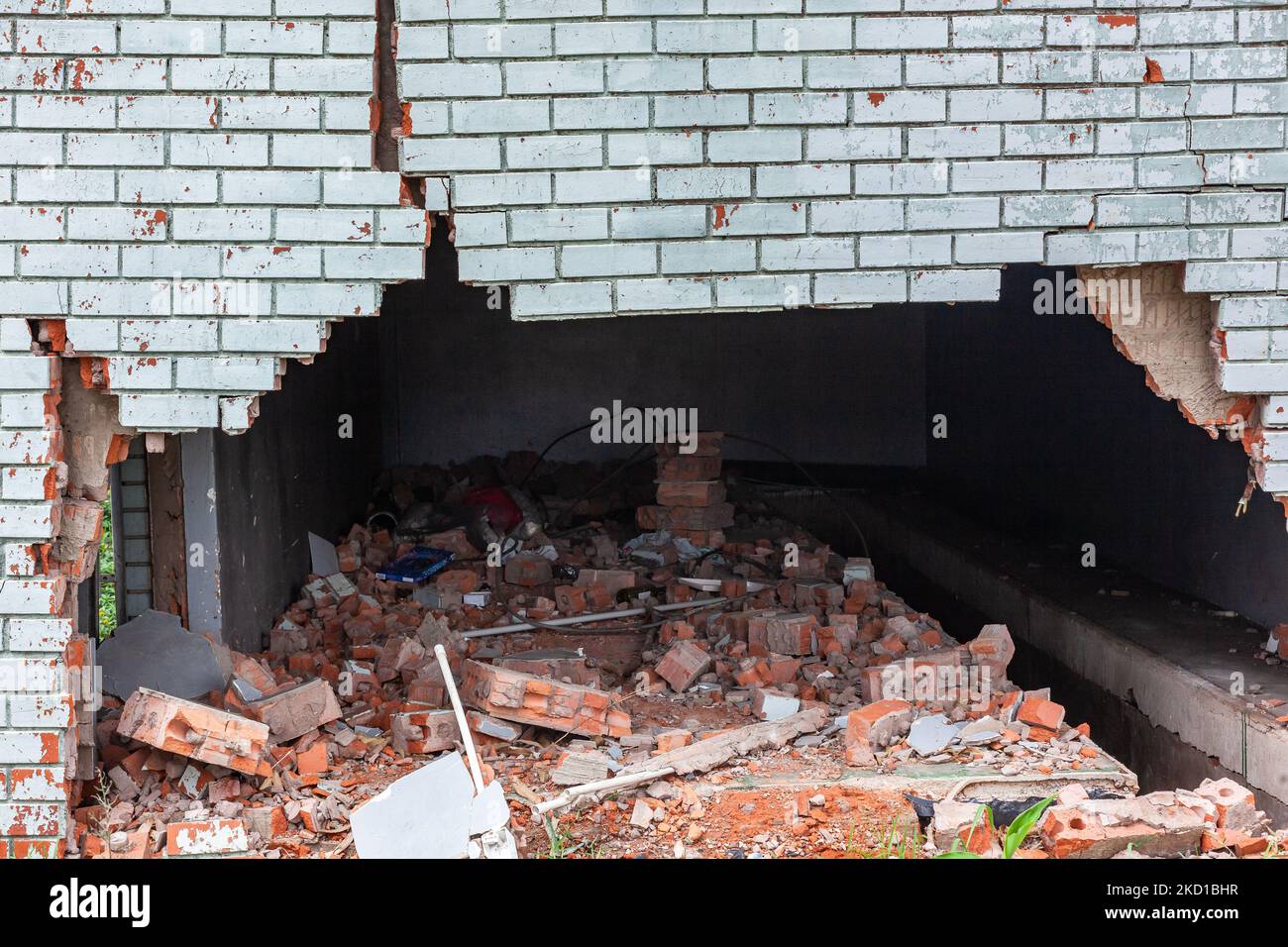 Building exterior brick wall with extreme damage cracks holding up from