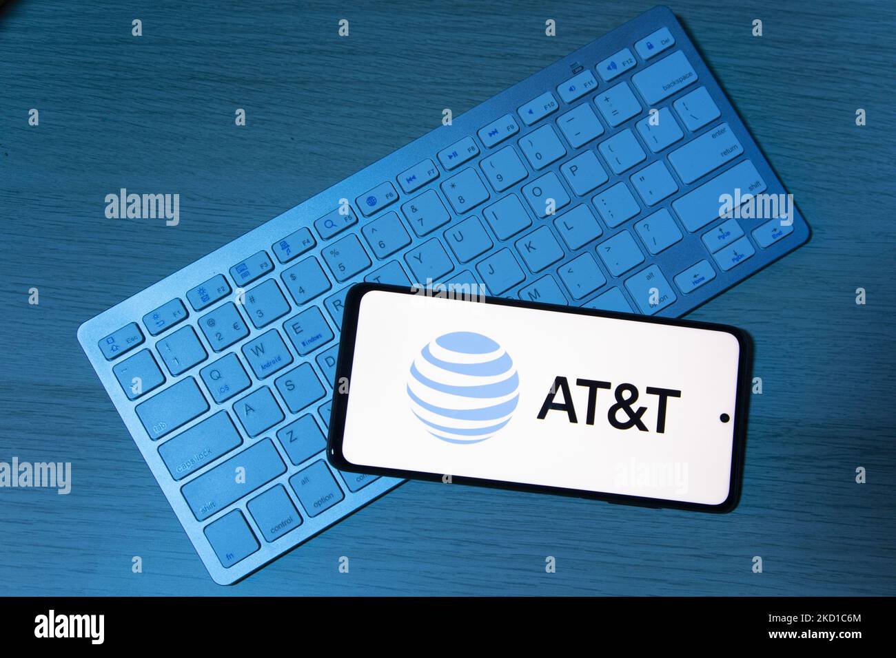 Photo illustration of AT&T logo symbol displayed on a mobile phone screen on top of a keyboard. AT&T Inc the American Telephone and Telegraph Company is an American multinational conglomerate holding company registered in Delaware. AT&T is the world's largest telecommunications company and the largest provider of mobile telephone services in the U.S.. Eindhoven, the Netherlands on January 27, 2022 (Photo Illustration by Nicolas Economou/NurPhoto) Stock Photo