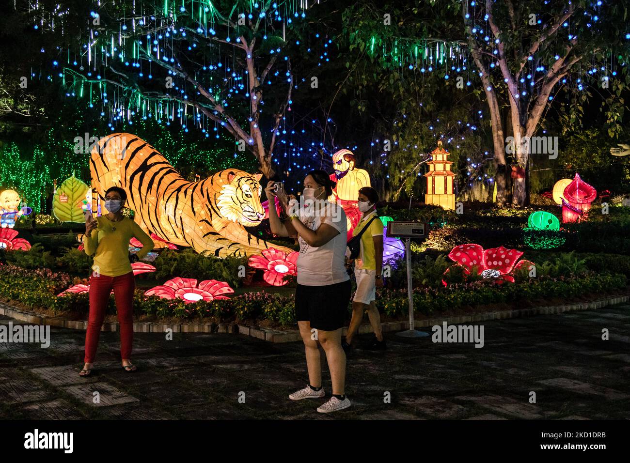People take photos of a Chinese Lunar New Year decorations at the Fo Guang Shan Dong Zen Temple ahead of the upcoming Lunar New Year of the Tiger on January 28, 2022 in Jenjarom outside Kuala Lumpur, Malaysia. (Photo by Mohd Firdaus/NurPhoto) Stock Photo
