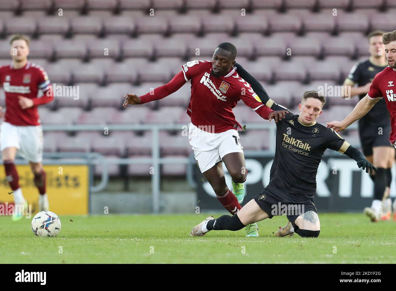 Northampton Town's Idris Kanu is challenged by Salford City's Ash Hunter during the second half of the Sky Bet League 2 match between Northampton Town and Salford City at the PTS Academy Stadium, Northampton on Saturday 29th January 2022. (Photo by John Cripps/MI News/NurPhoto) Stock Photo