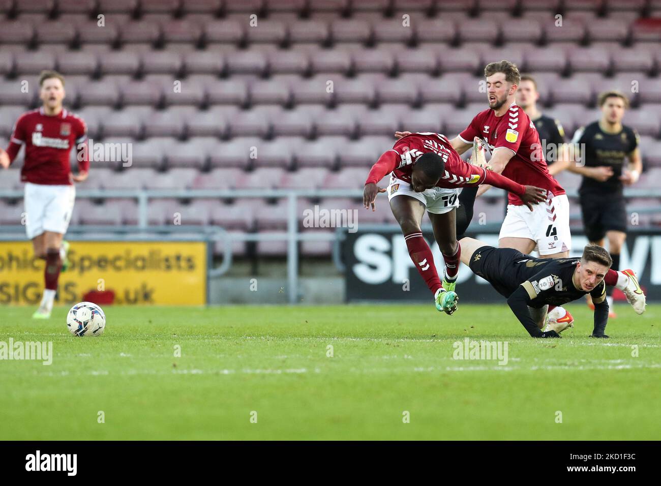 Northampton Town's Idris Kanu is challenged by Salford City's Ash Hunter during the second half of the Sky Bet League 2 match between Northampton Town and Salford City at the PTS Academy Stadium, Northampton on Saturday 29th January 2022. (Photo by John Cripps/MI News/NurPhoto) Stock Photo