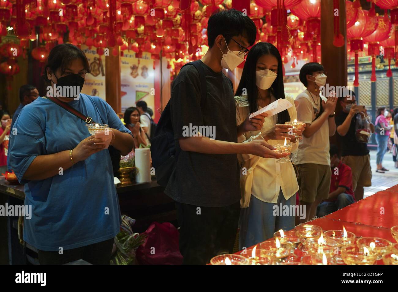 People light candles as they pray for good fortune to mark the Chinese
