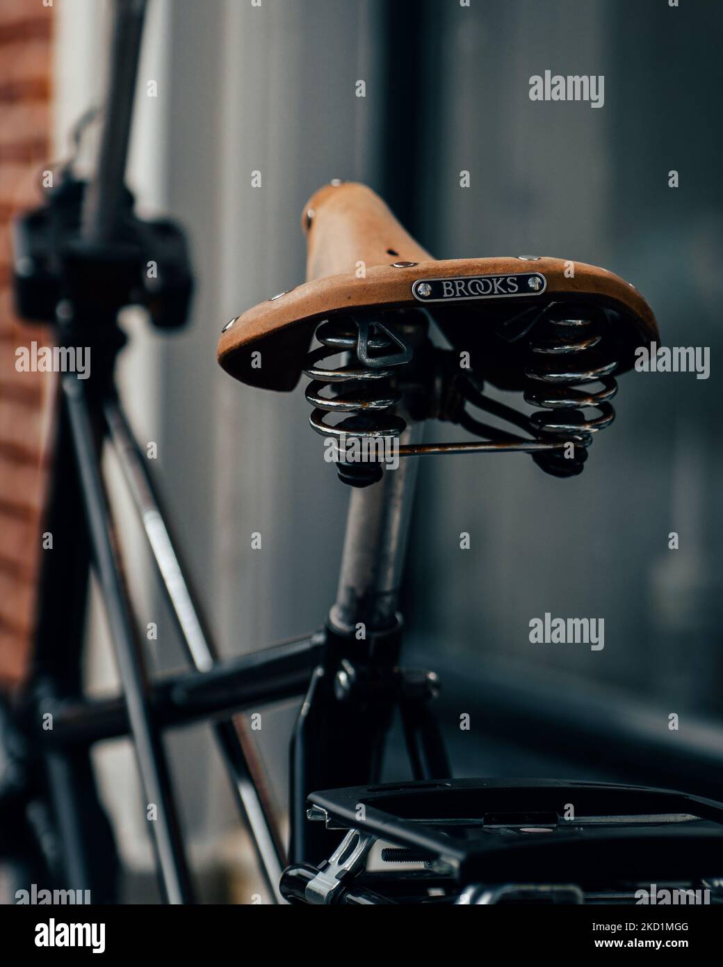 A selective focus shot of a bicycle with a saddle from a company called Brooks England Stock Photo