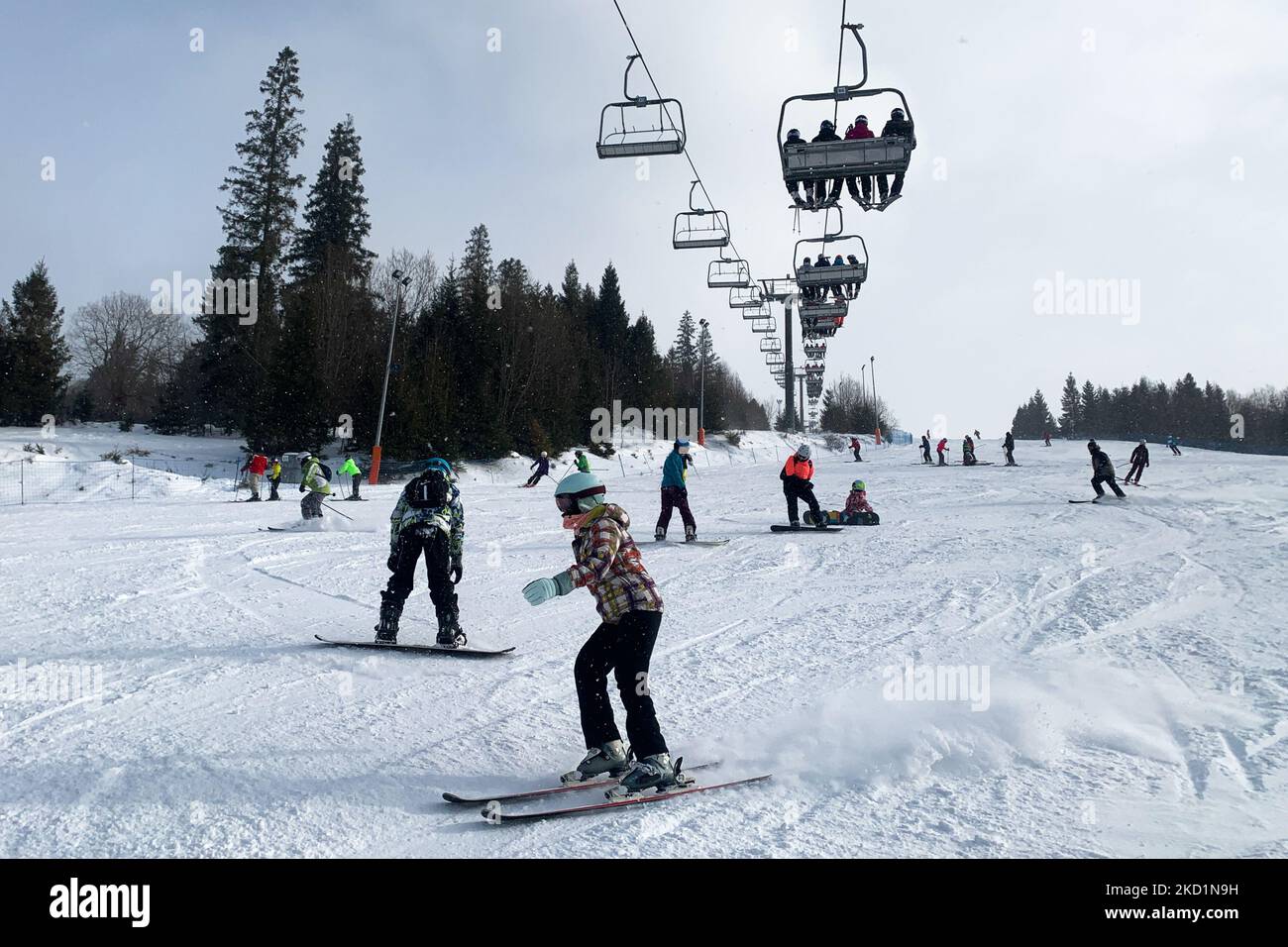 People go skiing and snowboarding on the ski slope in Jurgow, Poland on February 1, 2022. (Photo by Jakub Porzycki/NurPhoto) Stock Photo