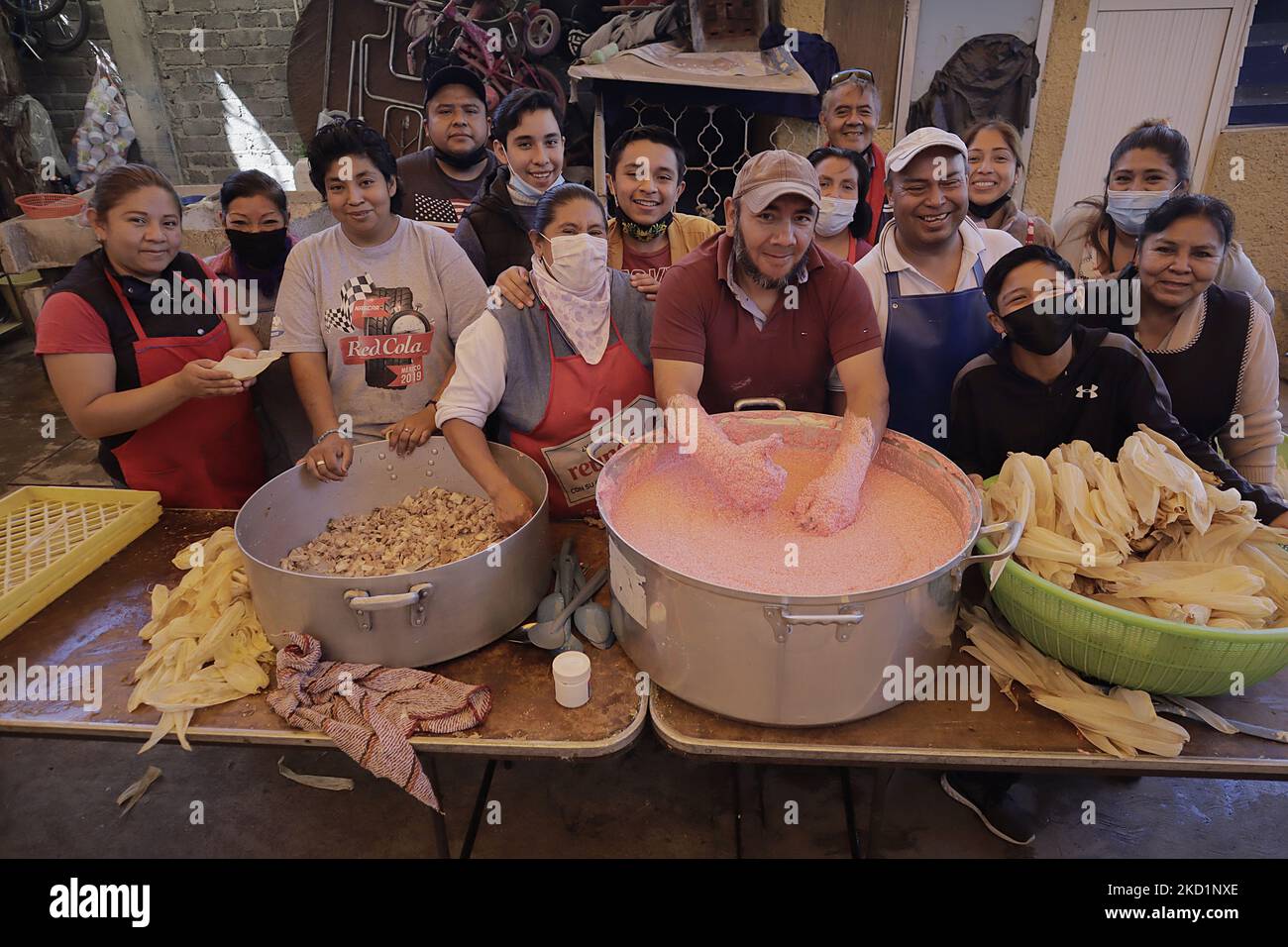 Inhabitants of San Francisco Culhuacán in Mexico City pose during the making of tamales on the occasion of Candlemas Day, which celebrates the period that closes the cycle of Christmas festivities within the Catholic Church. The tamale (from the Nahuatl tamalli, which means wrapped) is a Mexican food made from corn, filled with various ingredients, cooked in a bundle of vegetable leaves that can be made of corn, plantain, reed, chilaca or papatla. (Photo by Gerardo Vieyra/NurPhoto) Stock Photo