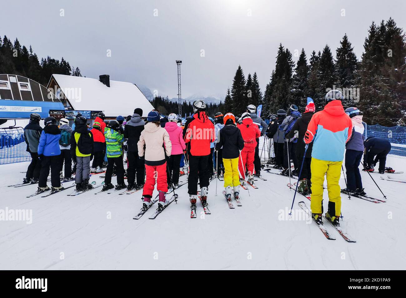 Skiers are waiting in a line to enter a ski lift at Jurgow Ski station ...