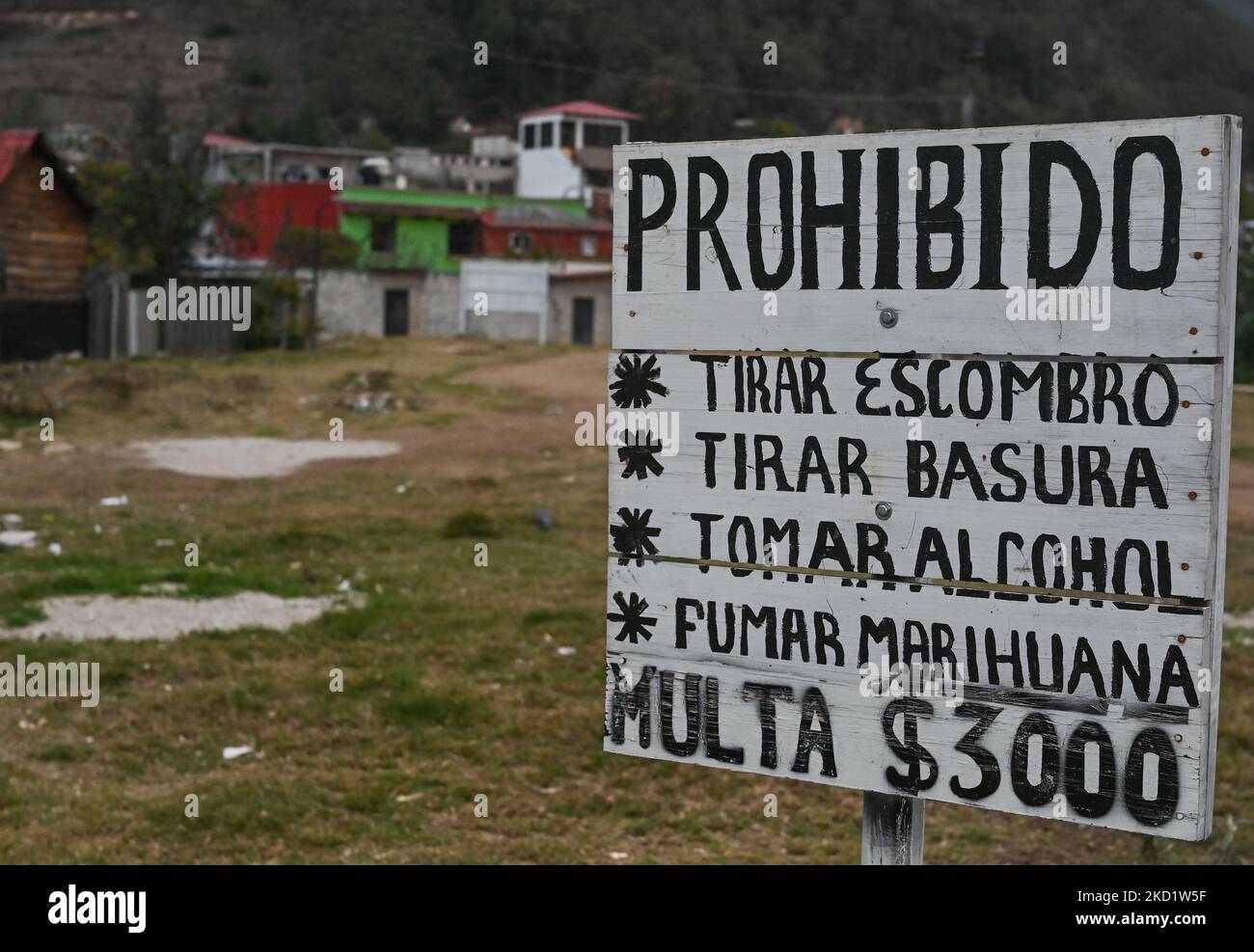 A warning sign with words 'Forbidden. Throwing rubbish, Throwing trash