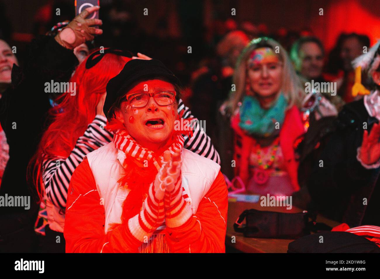 A concert goer sings along during the carnival concert held in Cologne, Germany on Feb 4, 2022 as Omicron waves hits new record in Germany (Photo by Ying Tang/NurPhoto) Stock Photo