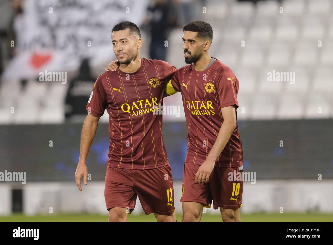 Rodrigo Tabata (12) and Hassan Al-Haydos (10) walk off the field at half time during the QNB Stars League match between Al Gharafa and Al Sadd on 5 February, 2022 at the Jassim Bin Hamad Stadium in Doha, Qatar. (Photo by Simon Holmes/NurPhoto) Stock Photo