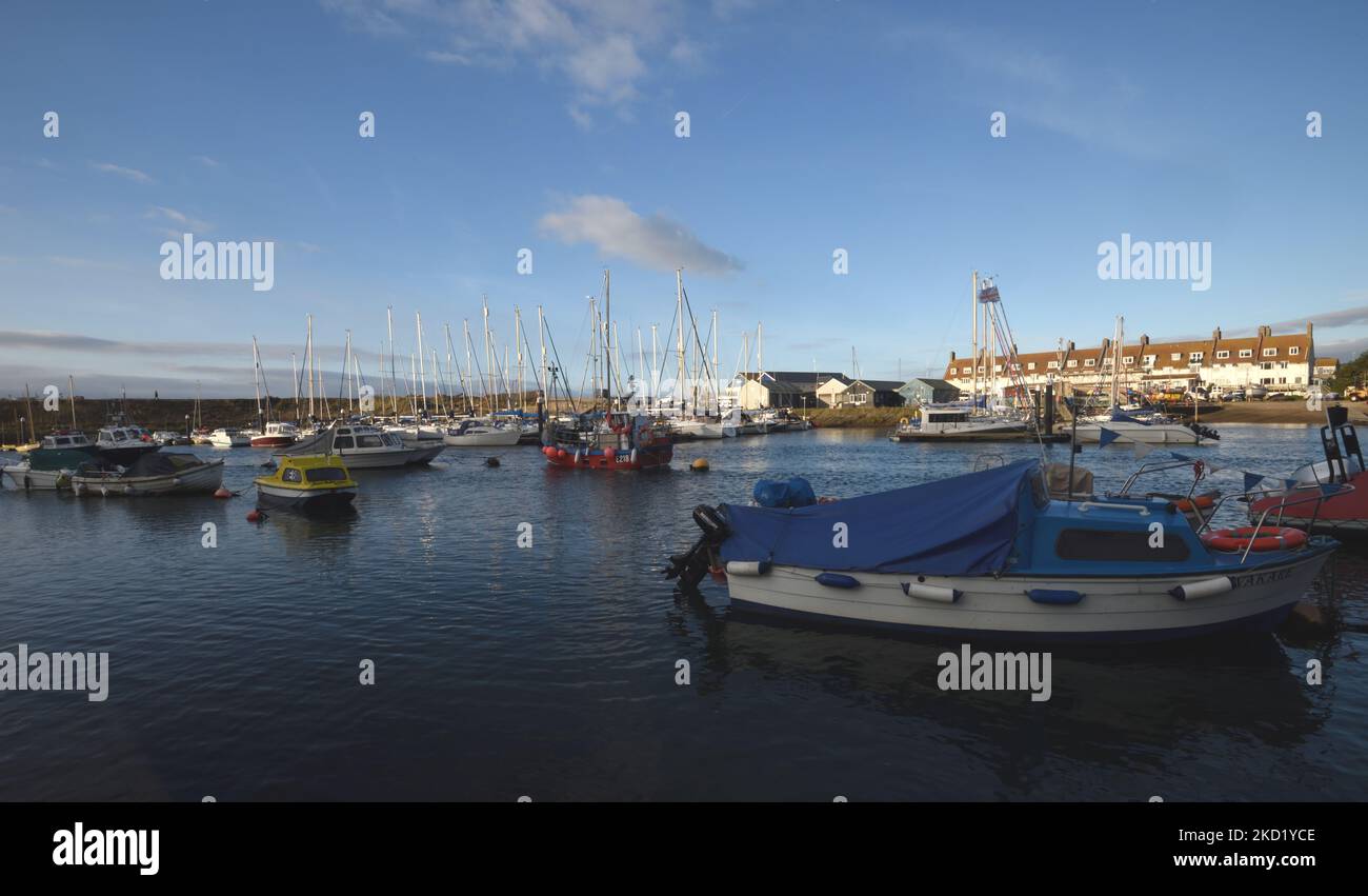 Boats moored in Axemouth Harbour. Looking across the River Axe to Seaton. Seaton, Devon, UK. Stock Photo