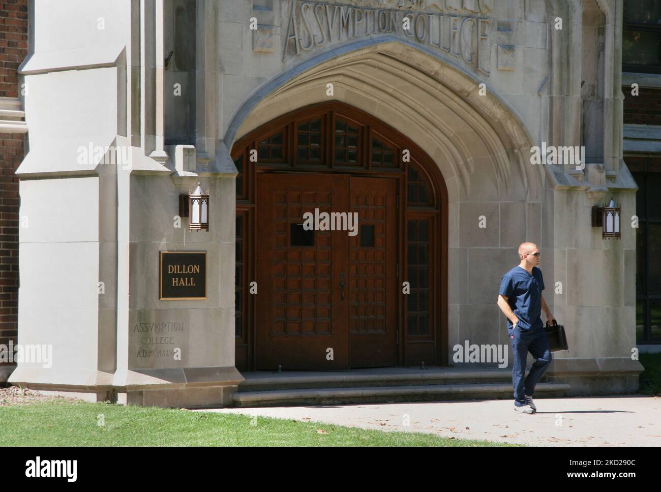 Student outside Dillon Hall at the Assumption College building of the ...