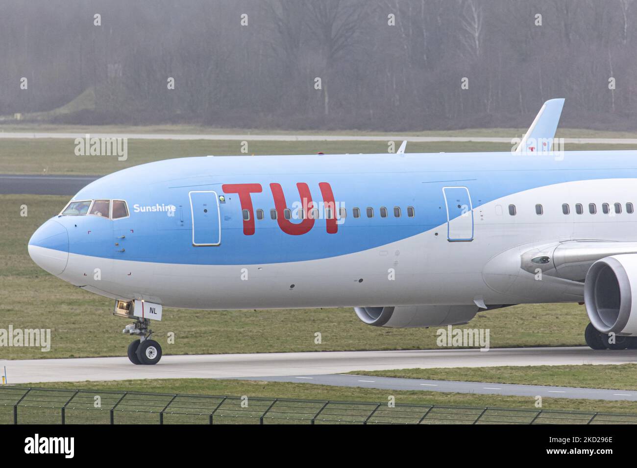 Close-up at the cockpit with the red logo inscription visible. TUI Airlines Belgium Boeing 767-300ER aircraft as seen on final approach flying, landing on the runway and taxiing at Eindhoven Airport EIN performing a rare Dutch domestic route. The wide-body Boeing B767 passenger airplane arrives from Amsterdam Schiphol Airport and has as a destination a charter flight to Bardufoss in Norway with flight number OR9531. The jet plane has the registration OO-JNL and the name Sunshine. TUI fly former Jetairfly, ArkeFly, is a Belgian scheduled and charter airline, subsidiary of TUI Group, the German  Stock Photo