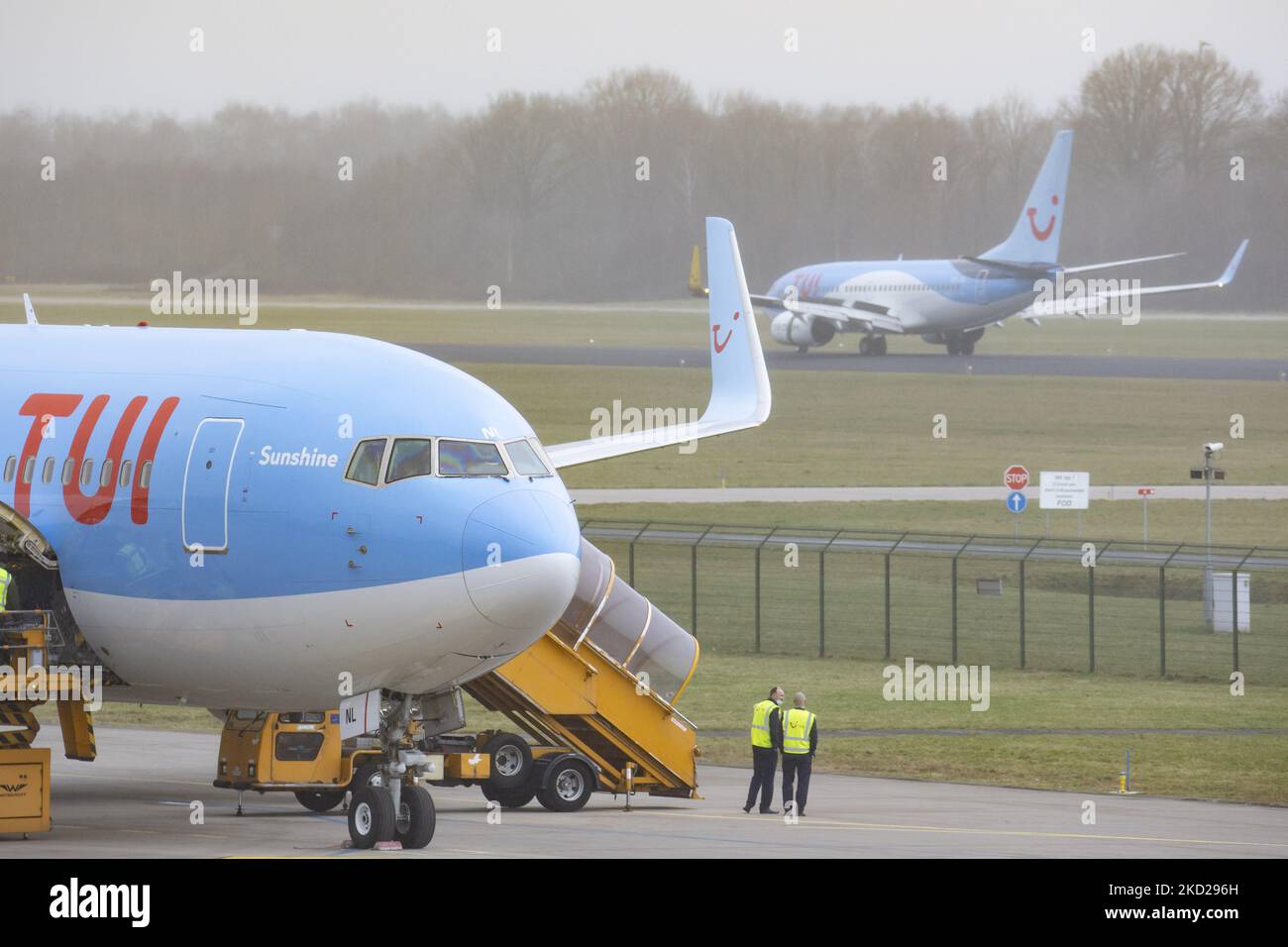 TUI Airlines Belgium Boeing 767-300ER aircraft as seen on parked at the tarmac while another TUI 737 is landing at Eindhoven Airport EIN performing a rare Dutch domestic route. The wide-body Boeing B767 passenger airplane arrives from Amsterdam Schiphol Airport and has as a destination a charter flight to Bardufoss in Norway with flight number OR9531. The jet plane has the registration OO-JNL and the name Sunshine. TUI fly former Jetairfly, ArkeFly, is a Belgian scheduled and charter airline, subsidiary of TUI Group, the German multinational travel and tourism company, largest leisure company  Stock Photo