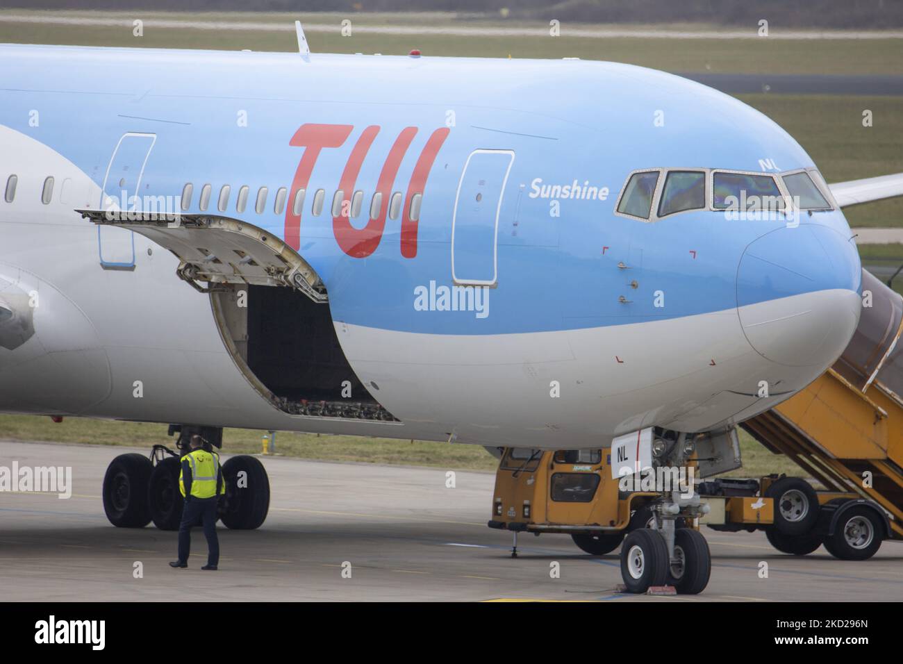 The Cargo door open under the TUI logo. TUI Airlines Belgium Boeing 767-300ER aircraft as seen on final approach flying, landing on the runway and taxiing at Eindhoven Airport EIN performing a rare Dutch domestic route. The wide-body Boeing B767 passenger airplane arrives from Amsterdam Schiphol Airport and has as a destination a charter flight to Bardufoss in Norway with flight number OR9531. The jet plane has the registration OO-JNL and the name Sunshine. TUI fly former Jetairfly, ArkeFly, is a Belgian scheduled and charter airline, subsidiary of TUI Group, the German multinational travel an Stock Photo