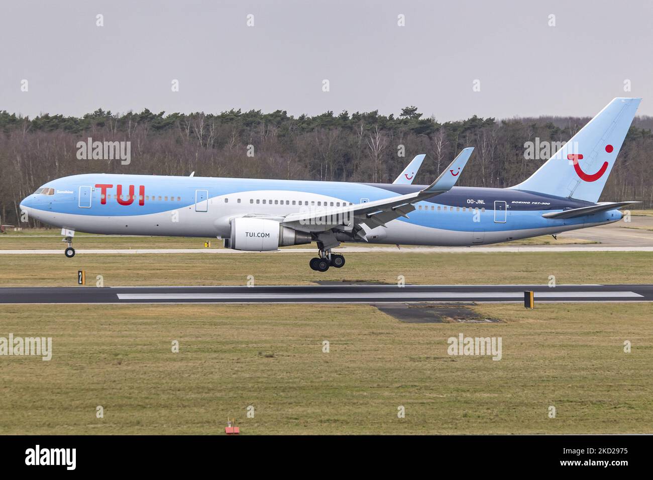 TUI Airlines Belgium Boeing 767-300ER aircraft as seen on final approach flying, landing on the runway and taxiing at Eindhoven Airport EIN performing a rare Dutch domestic route. The wide-body Boeing B767 passenger airplane arrives from Amsterdam Schiphol Airport and has as a destination a charter flight to Bardufoss in Norway with flight number OR9531. The jet plane has the registration OO-JNL and the name Sunshine. TUI fly former Jetairfly, ArkeFly, is a Belgian scheduled and charter airline, subsidiary of TUI Group, the German multinational travel and tourism company, largest leisure compa Stock Photo