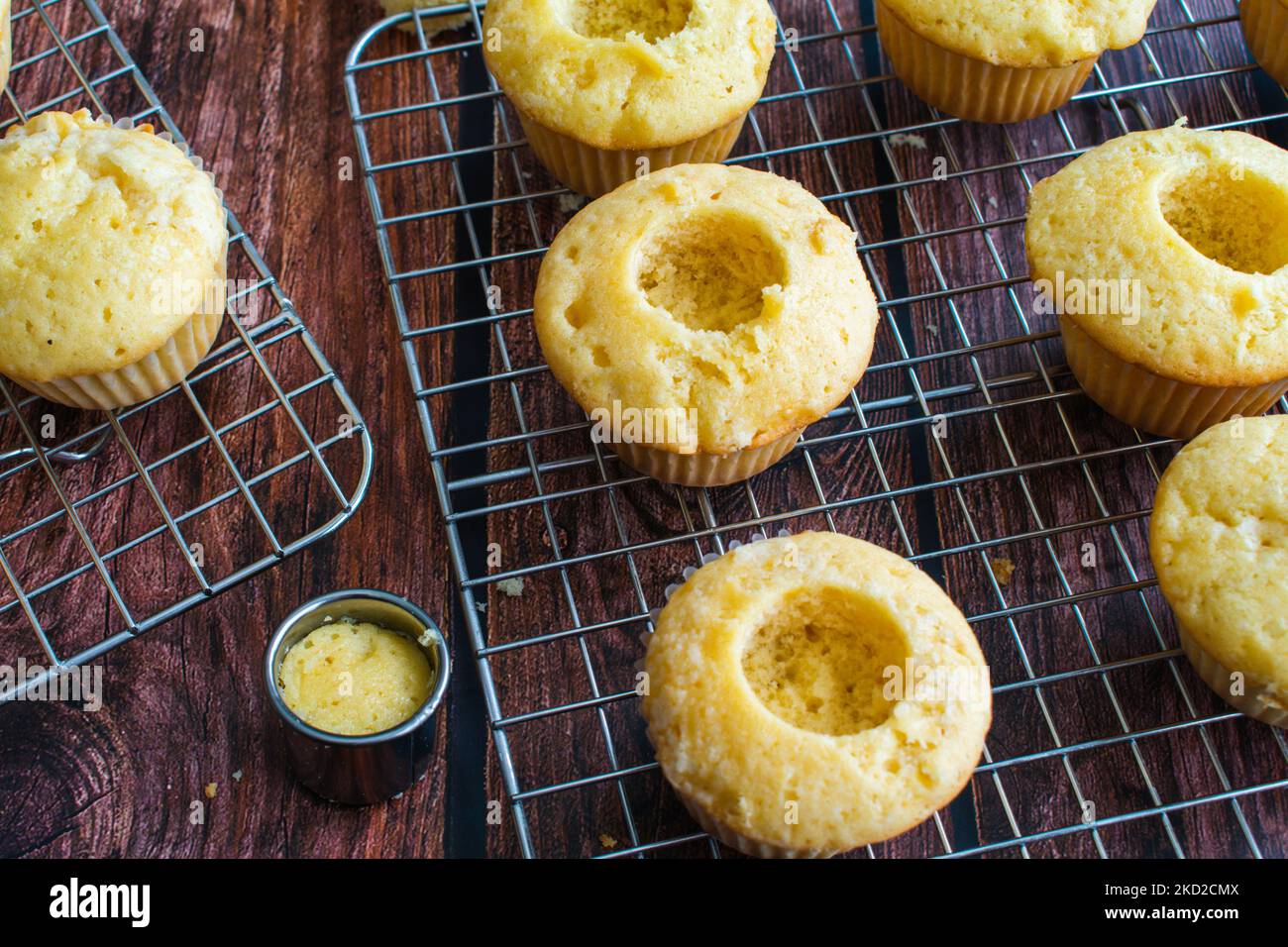 Cored Vanilla Cupcakes on a Wire Cooling Rack Vanilla cupcakes with