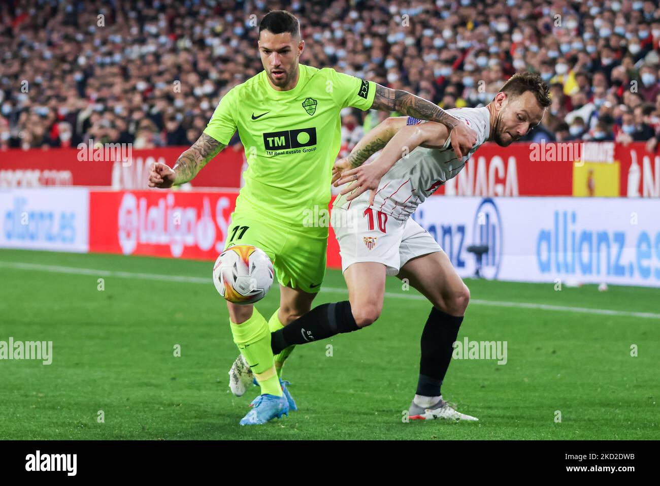Tete Morente of Elche CF in action with Ivan Rakitic of Sevilla CF during the La Liga Santader match between Sevilla CF and Elche CF at Ramon Sanchez Pizjuan in Seville, Spain, on February 11, 2022. (Credit: Jose Luis Contreras) (Photo by DAX Images/NurPhoto) Stock Photo