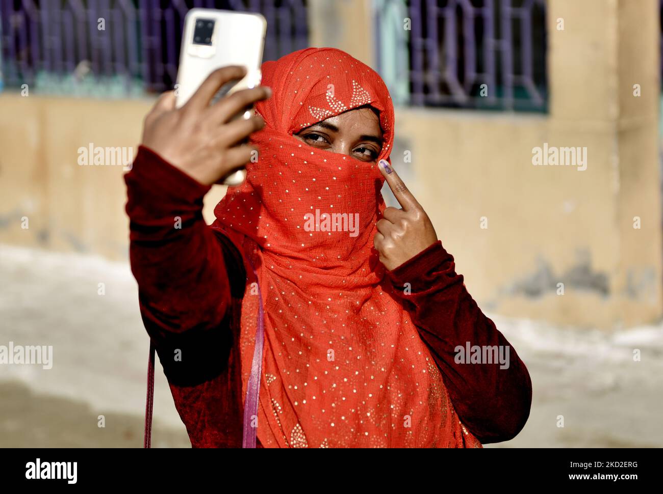 A Muslim woman clicks a selfie picture after she casts her vote in a polling booth during West Bengal Municipal Election in Kolkata, India, 12 February, 2022. (Photo by Indranil Aditya/NurPhoto) Stock Photo