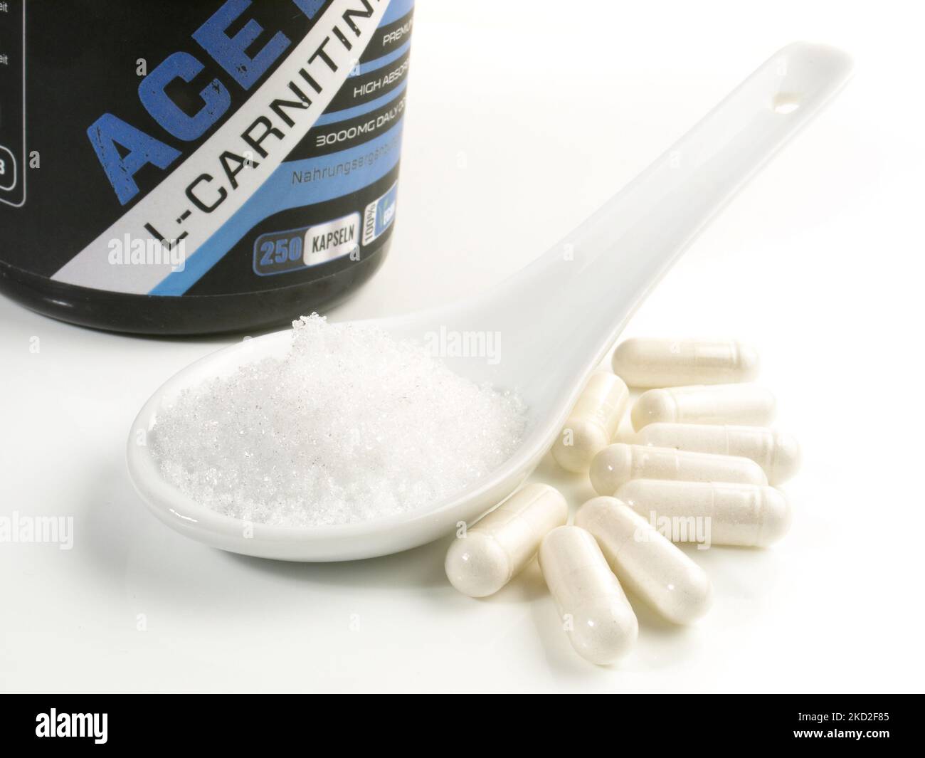 Carnitine Powder with Capsules isolated on white Background - Healthy Nutrition Stock Photo