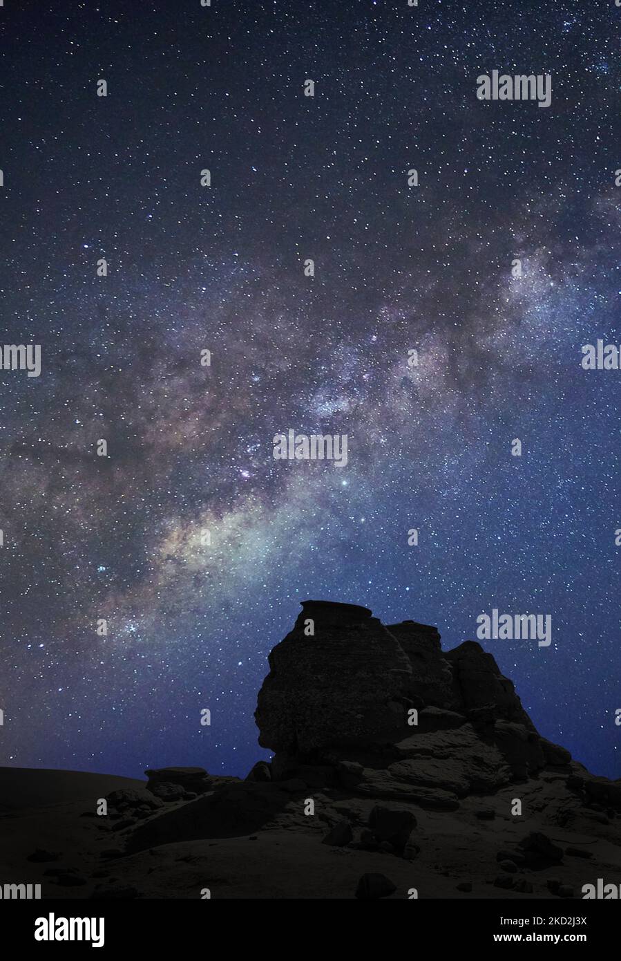 A mesmerizing starry night sky over the desert in a vertical shot Stock ...