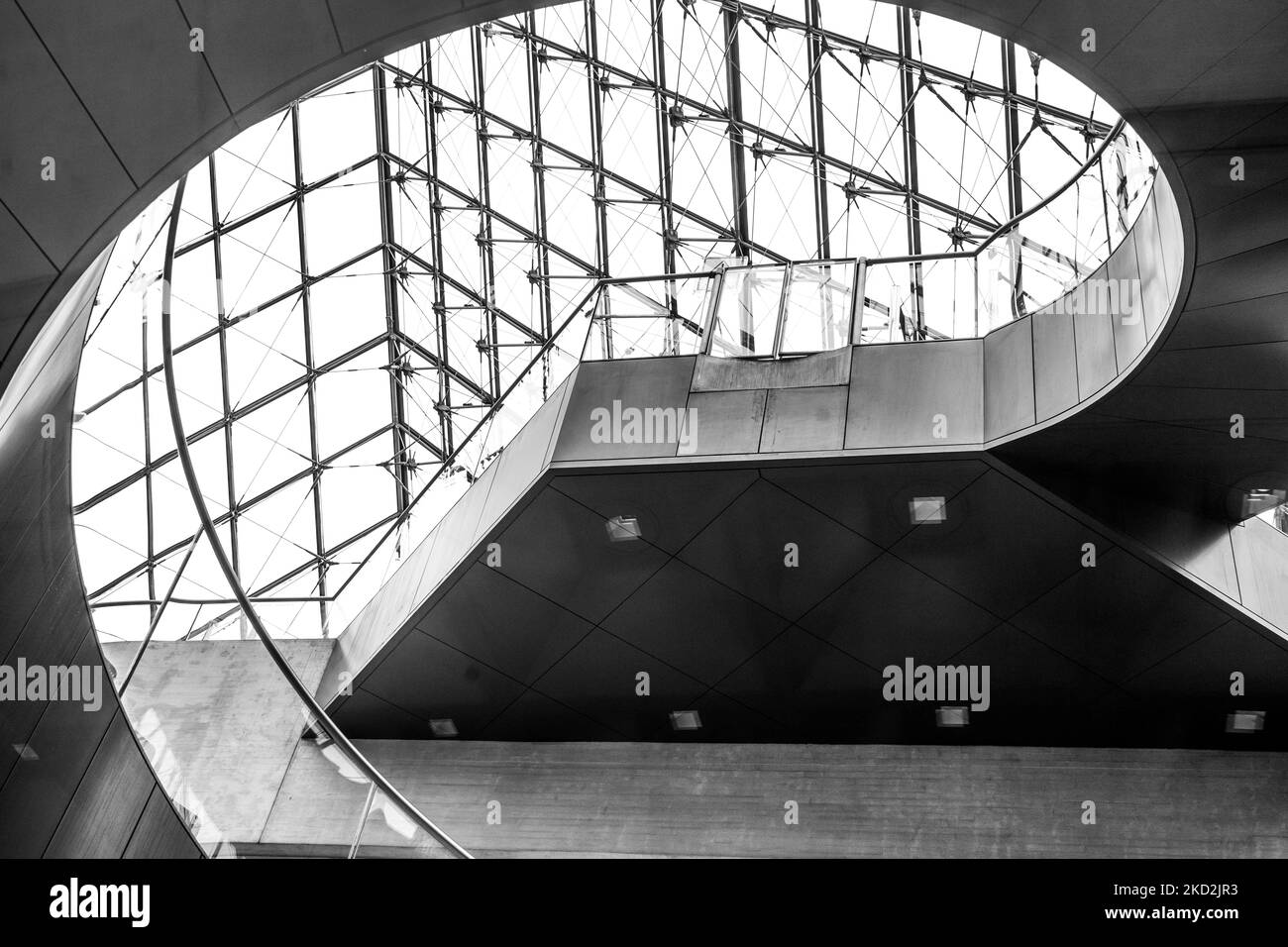 A grayscale shot of a spiral art inside Louvre Museum in Paris, France Stock Photo