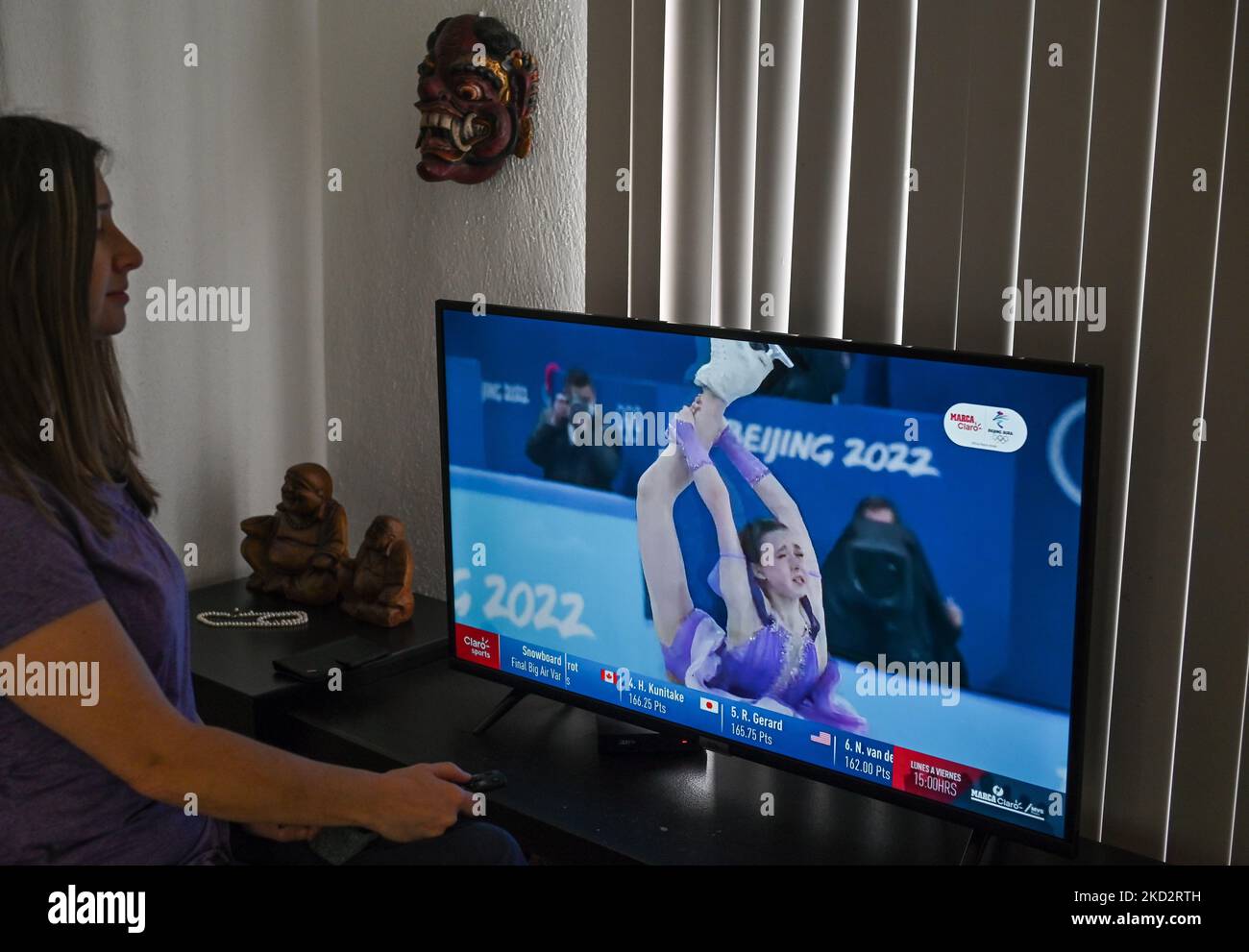 A woman watches a very emotional performance by the Russian ice skater