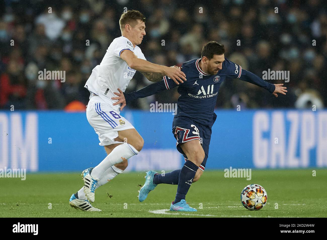 Leo Messi of PSG and Toni Kroos of Real Madrid compete for the ball during the UEFA Champions League Round Of Sixteen Leg One match between Paris Saint-Germain and Real Madrid at Parc des Princes on February 15, 2022 in Paris, France. (Photo by Jose Breton/Pics Action/NurPhoto) Stock Photo