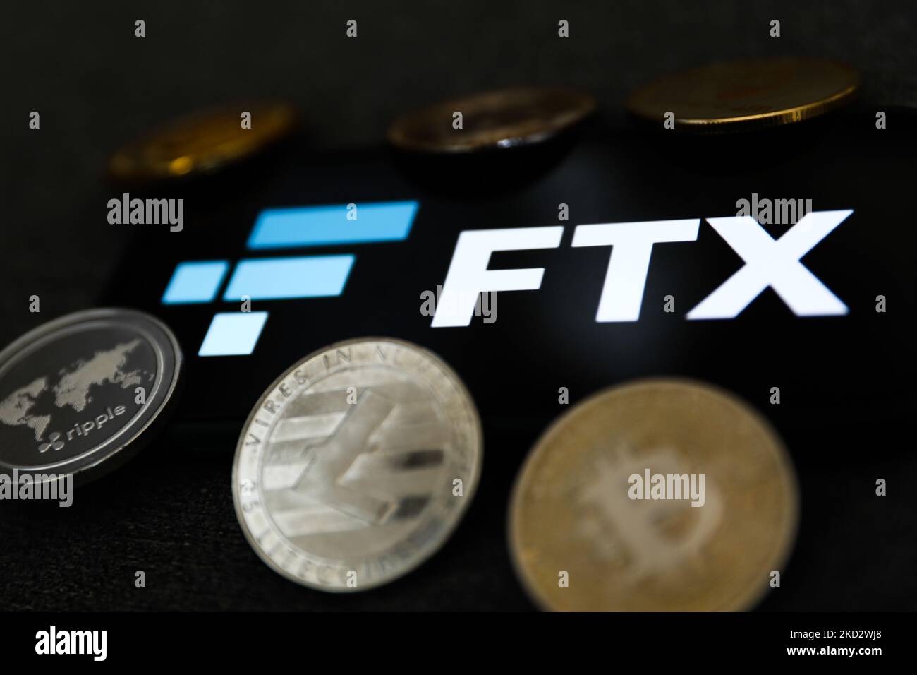 FTX logo displayed on a phone screen and representation of cryptocurrency are seen in this illustration photo taken in Krakow, Poland on February 16, 2022. (Photo illustration by Jakub Porzycki/NurPhoto) Stock Photo