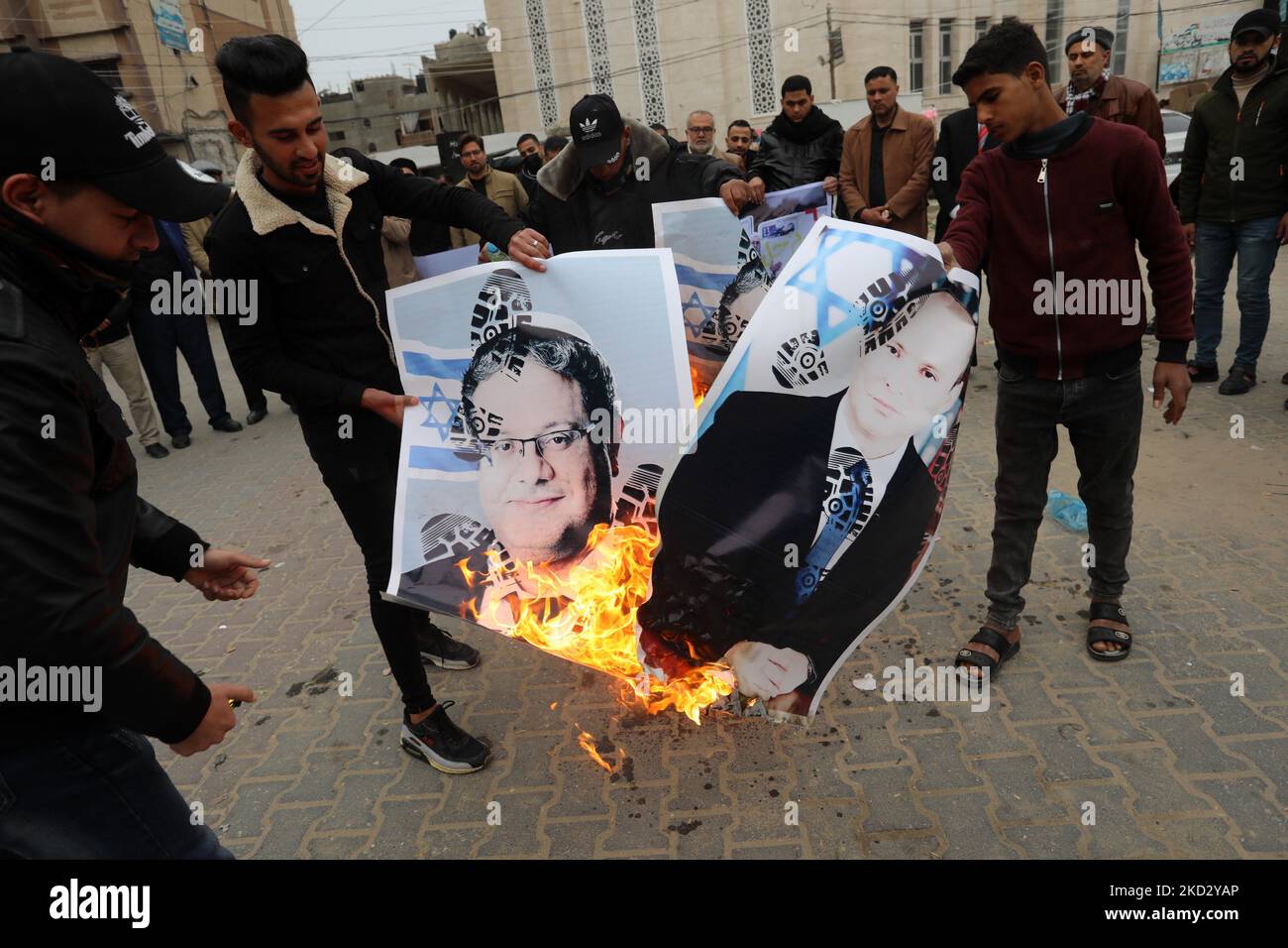 Palestinians burn pictures of Israeli Prime Minister Naftali Bennett and Itamar Ben-Gvir, member of Israel's Knesset (parliament) during a protest in solidarity with east Jerusalem neighbourhood of Sheikh Jarrah, in Khan Younis in the southern Gaza Strip on Feb. 17, 2022. Dozens of families in Sheikh Jarrah are facing displacement from their homes in coordinated efforts by the Israeli government and Jewish settler groups. (Photo by Majdi Fathi/NurPhoto) Stock Photo