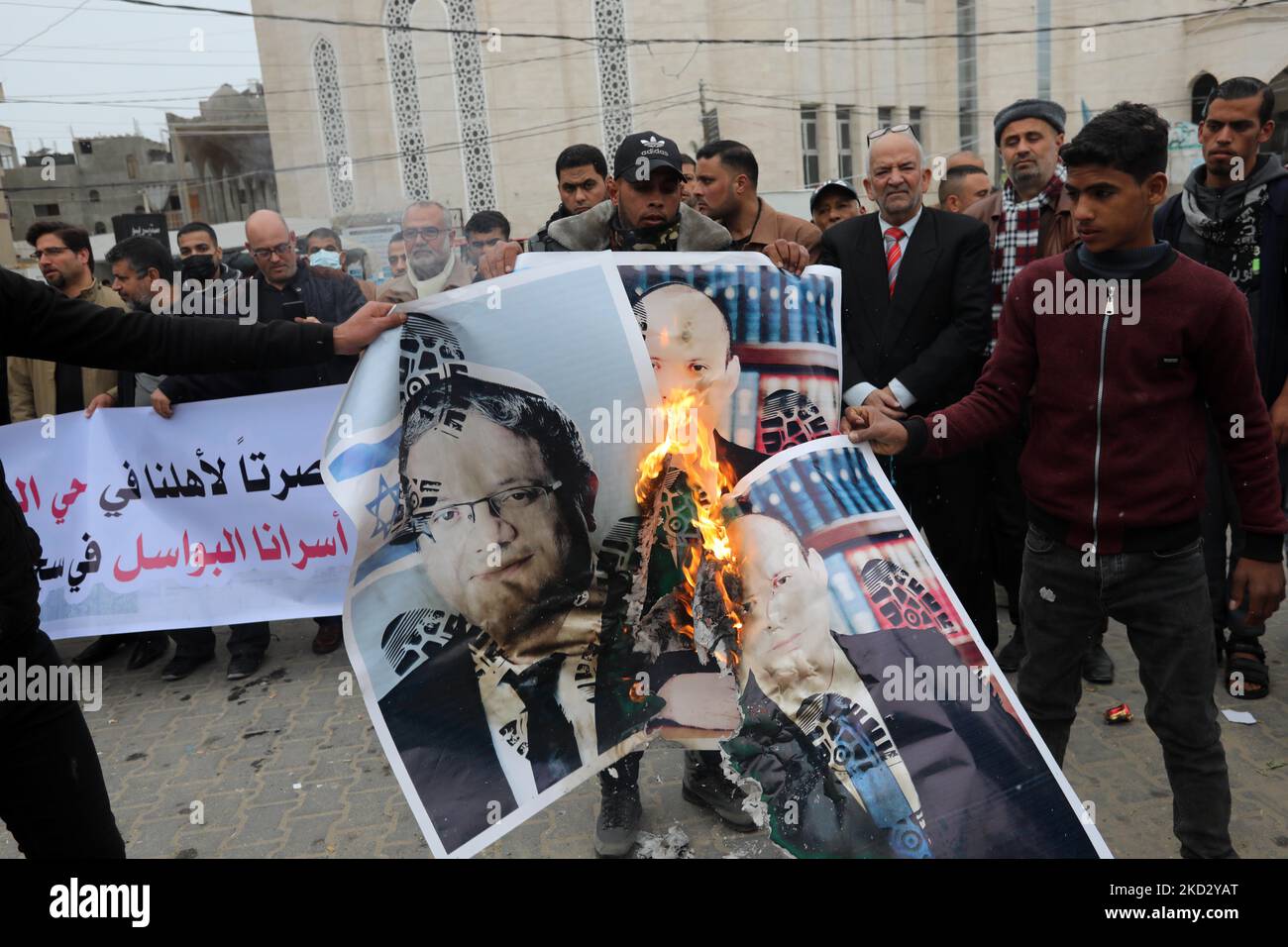 Palestinians burn pictures of Israeli Prime Minister Naftali Bennett and Itamar Ben-Gvir, member of Israel's Knesset (parliament) during a protest in solidarity with east Jerusalem neighbourhood of Sheikh Jarrah, in Khan Younis in the southern Gaza Strip on Feb. 17, 2022. Dozens of families in Sheikh Jarrah are facing displacement from their homes in coordinated efforts by the Israeli government and Jewish settler groups. (Photo by Majdi Fathi/NurPhoto) Stock Photo