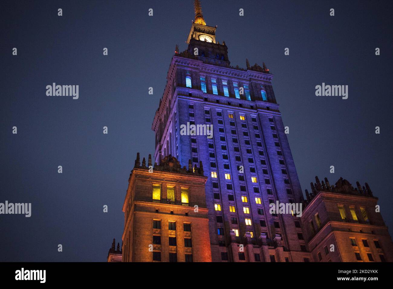 Palace of Culture and Science illuminated in national colors of Ukraine during Warsaw in solidarity with Ukraine protest in Warsaw on February 17, 2022. (Photo by Maciej Luczniewski/NurPhoto) Stock Photo