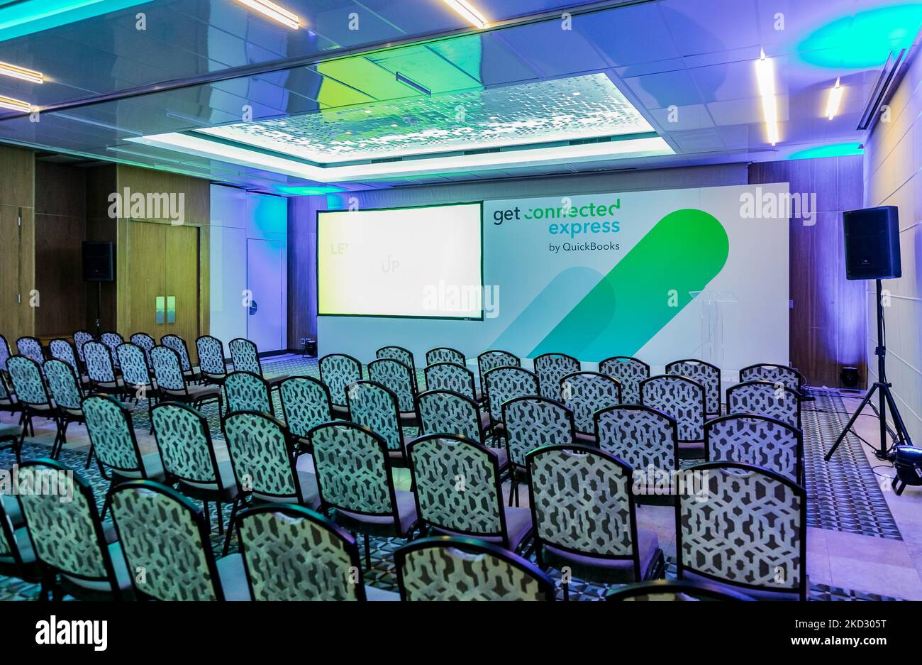 The empty seats in a small purple conference venue room of the Get Connected Express by QuickBooks Stock Photo