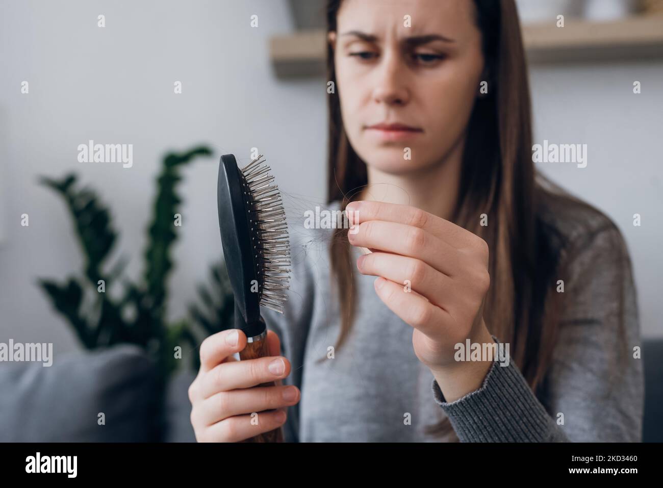 Close up of unhappy frustrated longhaired young woman looking at many