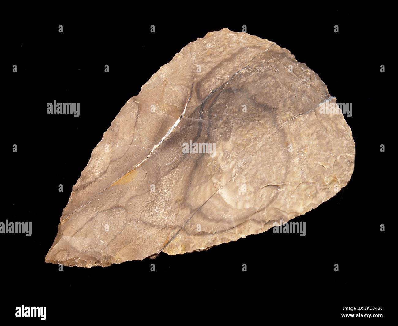 Stone Age Hand Axe out of Flintstone on black Background Stock Photo