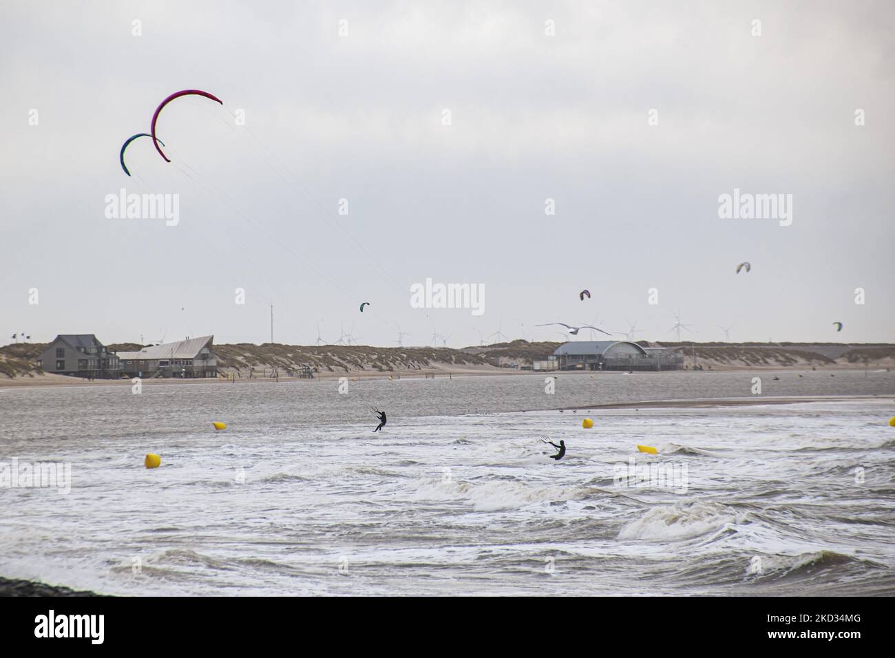 People do kitesurf over the waves and other watersports as storm Eunice hits with strong winds the Dutch shore. Storm Eunice hit the Netherlands after storm Dudley with wind gust speed exceeding 120km/h, resulting in damages in buildings, cars and killing people from trees falling. The government issued a red warning and 112 alarm emergency notifications on the phones before the storm hit.The Brouwersdam is a six kilometer long dam that connects the provinces of South Holland and Zeeland. It is part of the Delta Works and was opened to the public in 1971. Brouwersdam, Ouddorp, The Netherlands  Stock Photo