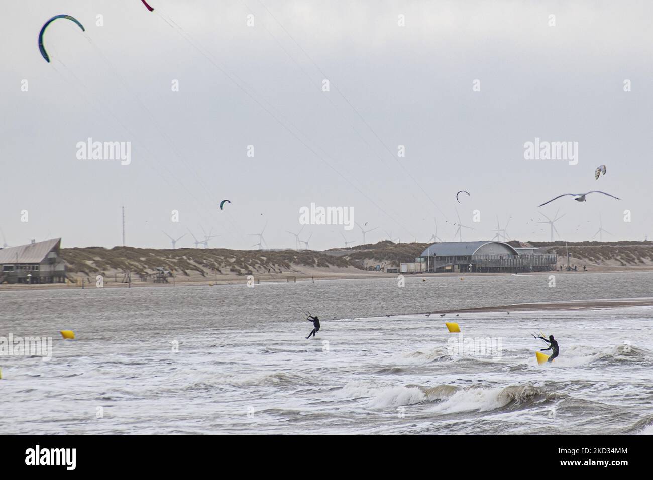 People do kitesurf over the waves and other watersports as storm Eunice hits with strong winds the Dutch shore. Storm Eunice hit the Netherlands after storm Dudley with wind gust speed exceeding 120km/h, resulting in damages in buildings, cars and killing people from trees falling. The government issued a red warning and 112 alarm emergency notifications on the phones before the storm hit.The Brouwersdam is a six kilometer long dam that connects the provinces of South Holland and Zeeland. It is part of the Delta Works and was opened to the public in 1971. Brouwersdam, Ouddorp, The Netherlands  Stock Photo